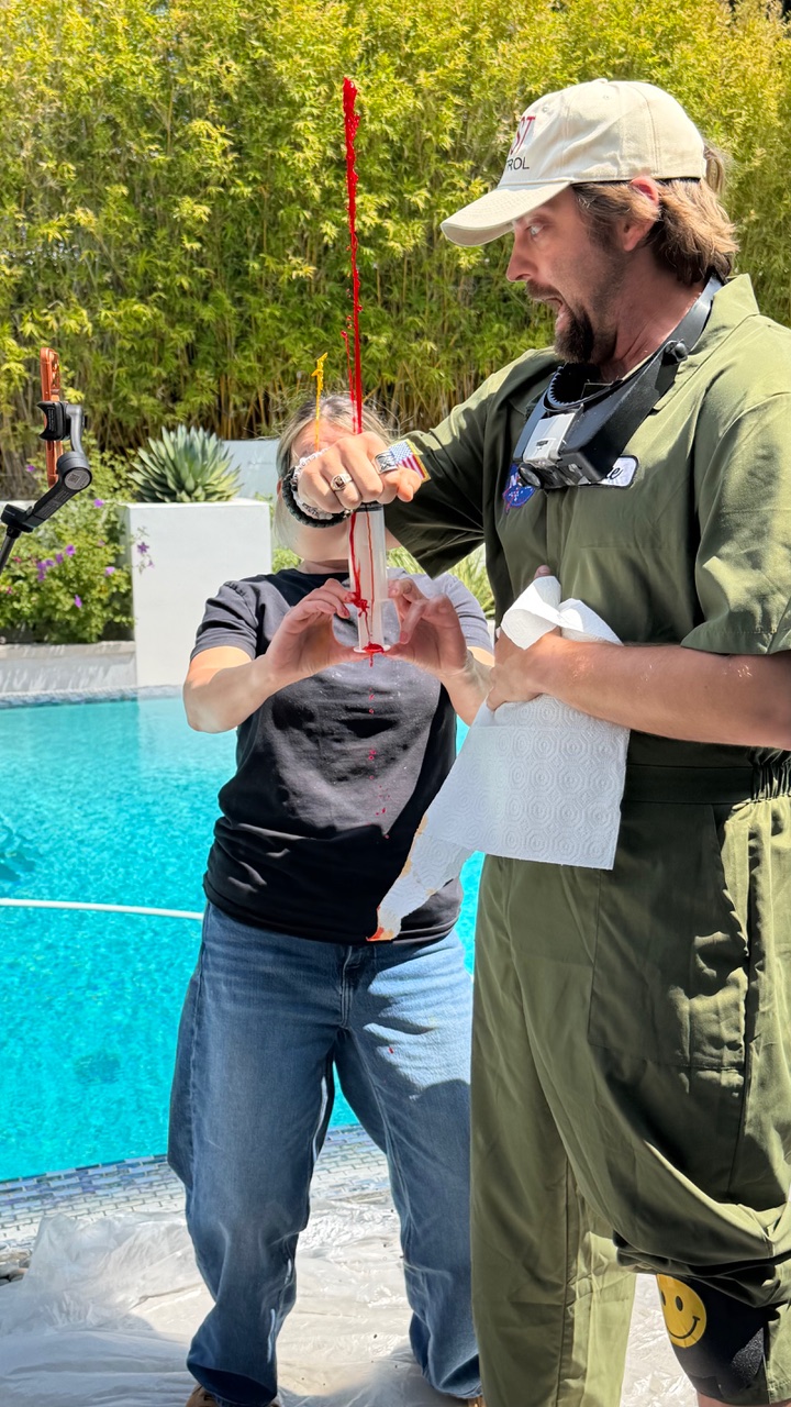 Blood gag rehearsal — squirt, catch, repeat.
